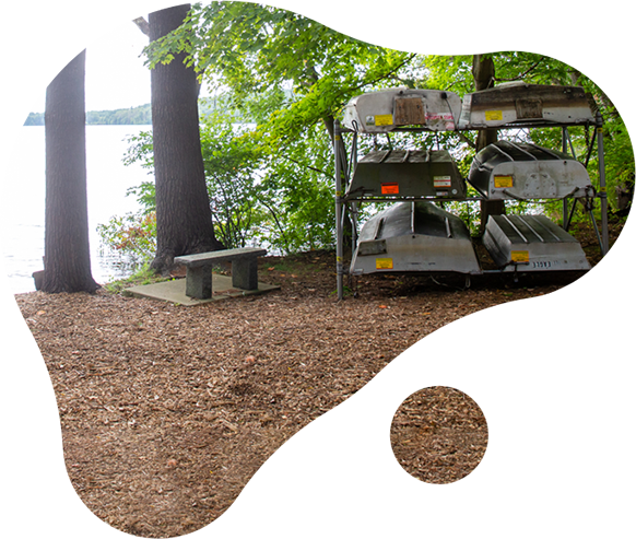 boats on a rack in front of Shenipsit Lake